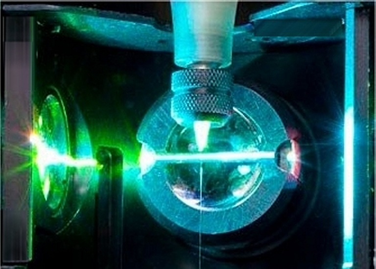 Green Laser hitting a metal sphere