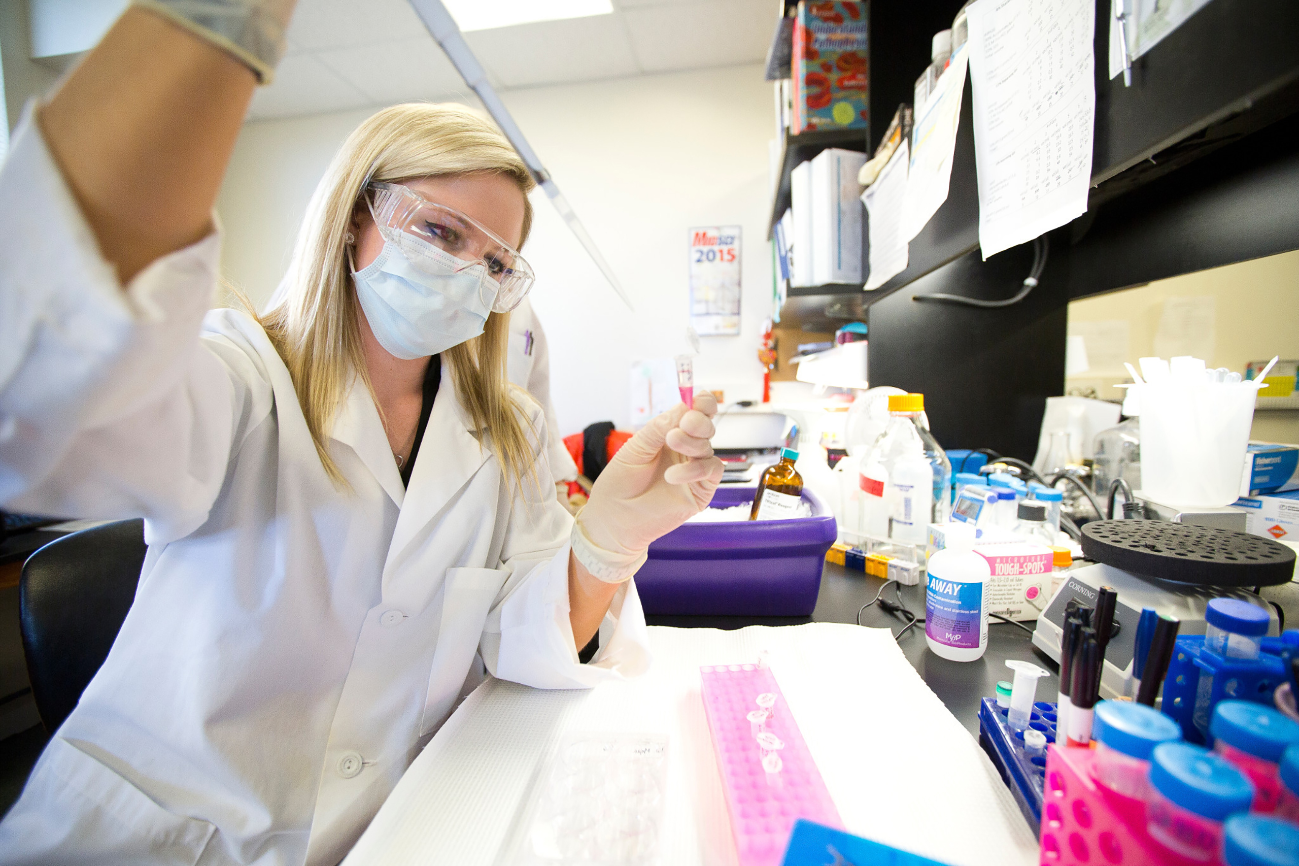 Researcher using a pipette in a laboratory